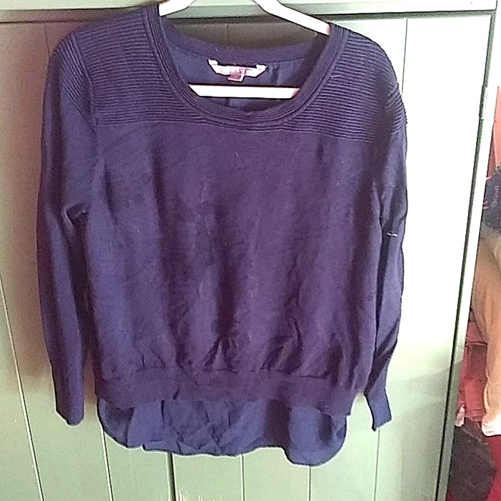 Navy knit sweater with silk underlay.